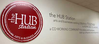 The Hub Station interior wall with logo and mission